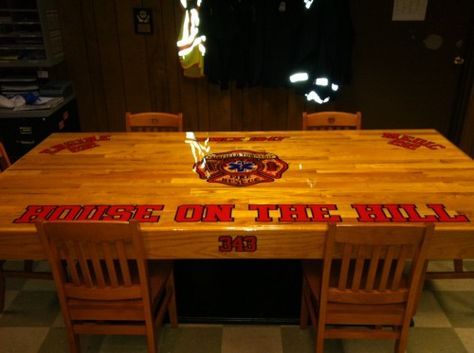 Jason Agoston sent this table in from Engine 212 and Medic 212 "House on the Hill" in Fairfield Township, Butler County, Ohio. They claim this might be the heaviest table in any firehouse. Jason and two other firefighters built the table themselves. It measures 8'x4', with a 2'x4' frame, sheet of plywood covered by oak… Firefighter Tables, Firehouse Decor, Fire Department Decor, Firefighter Room, Jason Robinson, Firefighter Crafts, Firefighter Home Decor, Fire Tables, Firefighter Decor