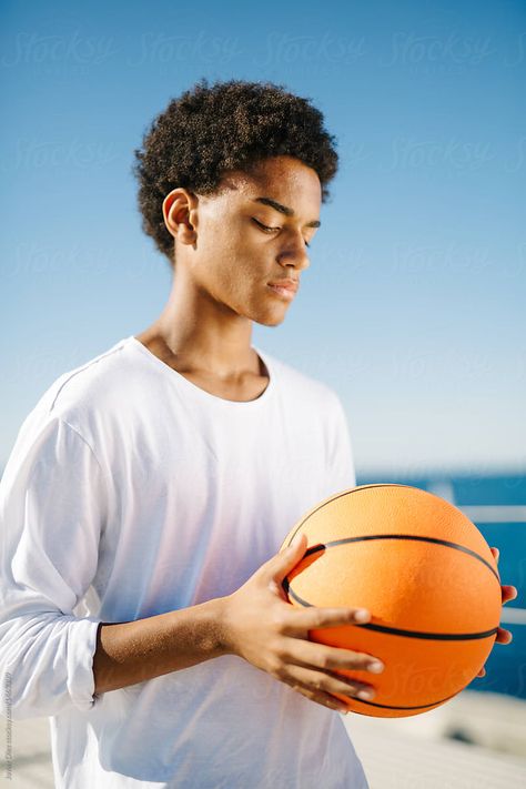 Handsome young fit man holding ball standing at seaside. Person Holding Ball Reference, Holding Ball Reference, Holding A Basketball, Ball Reference, Fit Man, Art References, Basketball Players, Pose Reference, Mens Fitness