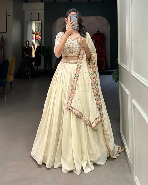 "Make a mesmerizing statement in our off-white lehenga choli! 🌷✨ Exquisite embroidery, shimmering sequins, and unparalleled elegance. Capture hearts and steal the spotlight effortlessly! #weareffortlessly #LehengaCholiLove #OffWhiteElegance #EmbroideredPerfection #SequinSparkle #FestiveFashion #EthnicChic #WeddingWear #LehengaGoals" ▪️Lehenga(Stitched) Lehenga Fabric : Georgette Lehenga work : Sequins and Thread Embroidery Work With Lace Border Lehenga Waist : SUPPORTED UP TO 42 Lehenga Cl... Lehnga Designs Indian Weddings, Wedding Chaniya Choli, Lehenga Sari, Zip Stitching, White Lehenga Choli, Lehenga Choli Designs, Stylish Kurtis Design, Lehenga Saree Design, Simple Lehenga