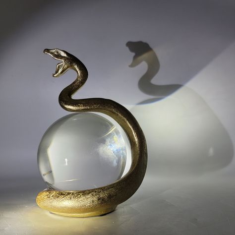 Gold Snake Statue with Crystal Ball, $50 including complimentary local delivery. Available now in our online store. www.ShopSBH.com Gold Snake Decor, Gold Snake Aesthetic, Crystal Ball Aesthetic, Snake Decorations, Crystal Ball Decor, Mystic Decor, Crystal Ball Holder, Snake Statue, Snake Decor