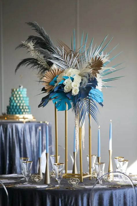 2024 Wedding Color Trends: Discover Seasonal Palettes & Themes Blue Feather Centerpieces, Avant Garde Centerpieces, Monstera Wedding Decor, Palm Tree Centerpieces, Blue Tropical Wedding, Blue And White Table Decor, Candles Tall, Blue Table Decorations, Unique Event Decor