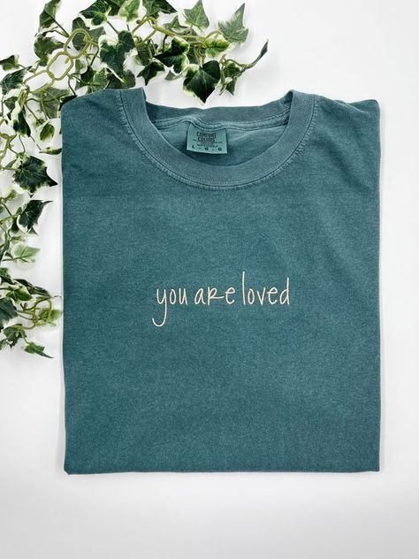 You are loved - Small / Comfort Color T-Shirt T shirt #tshirt t-shirt #t_shirt t shirts #tshirts t-shirts #t_shirts T shirt design #tshirtdesign T-shirt designs #t_shirtdesign T shirts designs #tshirtsdesigns 6.253 Comfort Colors Graphic Tees, Embroidered Tshirt Ideas, T Shirt Embroidery Ideas, Embroidery Shirt Designs, Embroidered Tshirts, Jesus Clothing, Simple Lettering, Jesus Clothes, Christian Shirts Designs