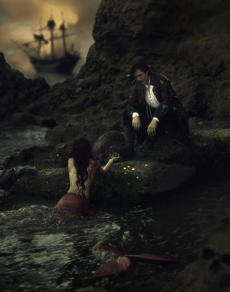 A pirate leans over the water as a mermaid brings him a crown and coins inside a sea cave.  A pirate ship is seen in the background Mermaid And Pirate Aesthetic, Mermaid Photography Photo Shoots, Sirene Aesthetic, Mermaid Romance, Wip Aesthetic, Mermaids Exist, Pirate Core, Mermaid Shoot, Mermaidcore Aesthetic