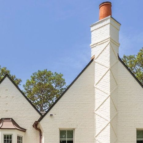 Thompson Custom Homes. on Instagram: "On the sixth day of #12homeswelove …  It is all the exterior details that make this home so great… the brick detailing the chimney… the copper gutters… the stone surround on the arched entry… the gas lanterns!  #brick #brickdetail #paintedbrick #white #exterior #gaslanterns #copper #stonearch #stoneentry #arches #customhome #luxury #warmth #home #homebuilding #architecture #houston #houstondesign #interior design #designhouston" Exterior Chimney, Brick Detailing, Arched Entry, Chimney Design, Houston Design, Copper Gutters, Brick Chimney, Brick Detail, White Canopy