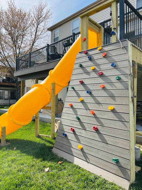 Deck Playground, Slide Off Of Deck, Deck With A Slide, Outdoor Kids Play Area Under Deck, Deck With Slide, Slide On Deck, Slide Off Deck, Diy Rock Climbing Wall With Slide, Backyard Climbing Wall