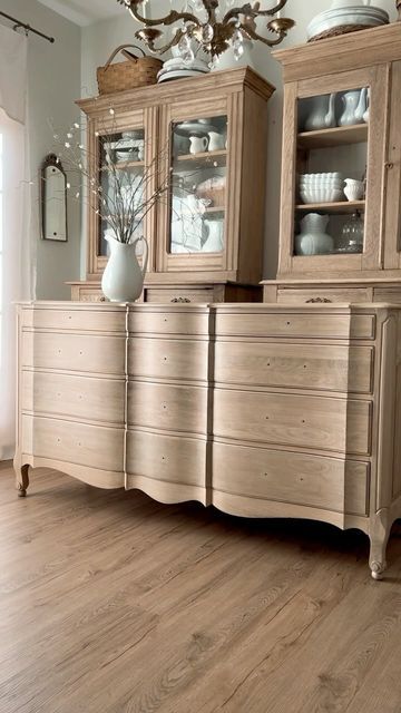 Krista on Instagram: "This is one amazing vintage French Provincial oak triple dresser! After stripping and sanding, I applied a wash of @sherwinwilliams Grecian Ivory, a coat of Farmhouse stain from @roveanddwell and finally coats of @minwaxusa Polycrylic in Clear Ultra Flat. I had to recruit my sons to come help move this one into the shop because it’s so heavy! But, it’s there and available! You can find the details in my Currently Available album on my Facebook page. #vintagefrenchprovincial #frenchfurniture #vintageoak #lightoak #modernvintage #vintagestyle #moderncottage #modernfarmhouse" Rustic French Provincial, Refinish French Provincial Dresser, French Provincial Dresser Makeover Ideas, French Provincial Hutch Makeover, Modern French Provincial Bedroom, French Provincial Furniture Makeover, Painted French Provincial Dresser, French Country Dresser, French Provincial Bedroom Furniture