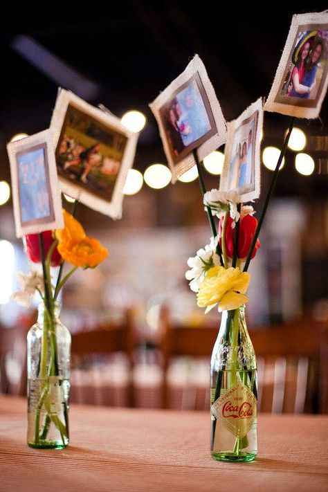 Photos On Sticks Centerpieces, Favors Rehearsal Dinner, Photos Centerpiece Ideas, Photos For Centerpieces, Using Photos As Centerpieces, Coke Bottle Centerpiece, Photo Vase Centerpiece, Diy Wedding Anniversary Decorations, Simple Event Table Decor