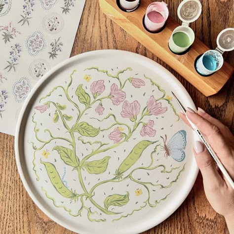 Ready to bake! @clay_and_coffee 🎨✍🏼 #ceramicpainting #sweetpea #butterfly #flowers #art #botanicals #southafrica Butterfly Ceramic Painting, Creative Pottery Painting Ideas, Flowers Pottery Painting, Cute Pottery Painting Ideas Plates, Painting Plates Ideas, Plate Painting Ideas Diy, Pottery Paint Ideas, Flower Pottery Painting, Pottery Painting Flowers