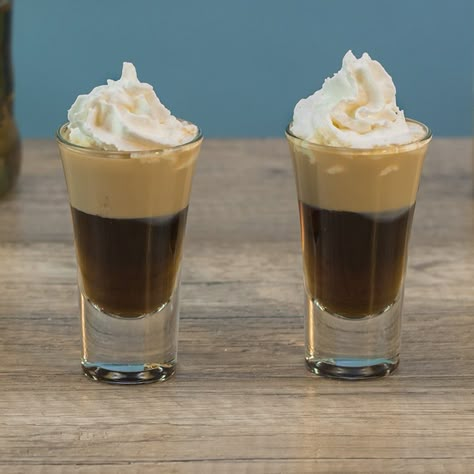 BANANA BREAD SHOOTER 3/4 oz. (22.5ml) Chocolate Liqueur 3/4 oz. (22.5ml) Banana Liqueur 1/2 oz. (15ml) Irish Cream Garnish: Whipped Cream PREPARATION 1. Add ice, chocolate liqueur and banana liqueur to shaking glass and combine well. Pour into shot glass. 2. Use a spoon to gently layer irish cream on top before finishing with whipped cream. DRINK RESPONSIBLY! (User Submitted by Brandon @ TipsyBartender.com) Holiday Shot Recipes, Amaretto Recipes, Tipsy Bartender Recipes, Drinking Shots, Layered Shots, Baileys Cocktails, Bachelorette Party Drinks, Shooter Recipes, Dessert Shots