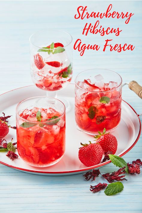 Quench your thirst with this fresh, strawberry hibiscus agua fresca. Aguas frescas or “fresh waters” are non-alcoholic beverages made of fresh fruits. Strawberries and hibiscus are the perfect combination for this refreshing recipe. #californiastrawberries #aguafresca #mocktail #beverage #strawberry #freshwater #infusedwater #nonalcoholicdrinks Fresco, Hibiscus Aqua Fresca, Auga Frescas, Hibiscus Agua Fresca, Hibiscus Refresher, Fruit Waters, Hibiscus Recipe, Summer Fruit Drinks, Roselle Hibiscus