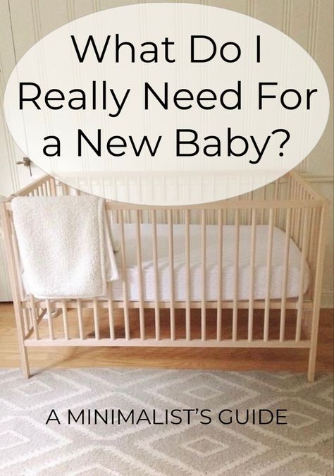 A crib made of natural wood with a cream blanket draped over the side. Nursery Decor Small Room, Nursery Ideas In Apartment, Cute Simple Nursery Ideas, Minimalist New Mom Essentials, Simple Apartment Nursery, How To Set Up Nursery Room, Furniture For Nursery, Loft Nursery Ideas Small Spaces, Nursery Room Essentials