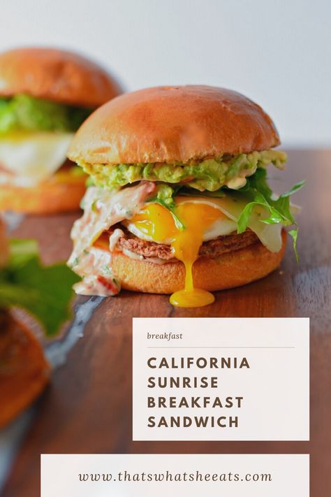 A breakfast sandwich stacked on a brioche bun with drippy egg yolk, avocado, mixed greens, and chicken sausage. Sausage Breakfast Sandwich, California Sunrise, Sunrise Breakfast, Brunch Burger, Egg And Cheese Sandwich, Breakfast Sandwich Recipes, Avocado Chicken, Breakfast Platter, Breakfast Burger