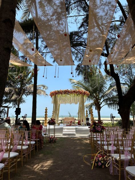 Indian Wedding Ceremony at Beleza By The Beach, Goa. This circular mandap is adorned with different flowers that give it a beautiful and unique look! The seating area is covered by drapes with hanging flowers that look mesmerizing in the afternoon wind.‎ ‎‎ ‎ ‎ ‎ ‎ ‎ ‎ ‎ ‎ ‎ ‎ ‎ ‎ Indian Wedding Decor | Wedding Mandap | Mandap Decor | Outdoor Wedding | Wedding Decor Ideas | Destination Wedding Indian Beach Wedding, Beach Wedding Setup, Indian Wedding Venue, Indian Destination Wedding, Goa Wedding, Indian Wedding Decor, Oceanfront Wedding, Destination Wedding Decor, Dream Wedding Decorations