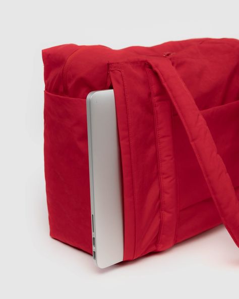 A travel bag optimized for flying: it fits under an airplane seat, on top of your roller bag, and on your shoulder. Exterior pockets keep your travel essentials within reach, including a tech pocket that fits up to a 16” laptop, and side pockets for your water bottle and boarding pass. The bag packs down into its interior detachable pouch for easy storage. Heavyweight nylon (59% Recycled) 16.5” W x 12.5” H x 6.5” D Interior snap pocket Side zip computer pocket: 16.5” W x 12.5” H Strap/Handle Dro Bag Packs, Small Clouds, Cabin Bag, Scrap Material, Candy Apple Red, Apple Red, Candy Apple, Candy Apples, Reusable Bags