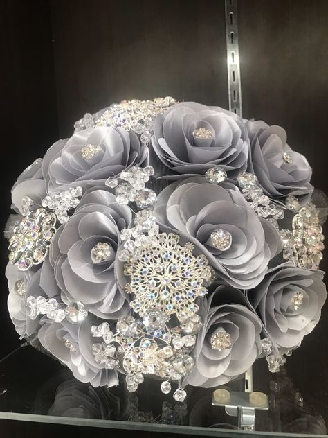 Silver Wedding Bouquets Brides, Silver Quince Decorations, Gray Quinceanera Theme, Grey Quinceanera Theme, Silver Prom Bouquet, Silver Quince Nails, Silver Quinceanera Theme, Silver Quince Dress, Silver Flower Arrangements