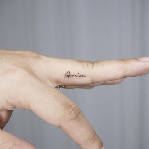 Tiny name finger tattoo Minimal Name Tattoo Ideas, Name Tattoos On Fingers For Women, Let Them Finger Tattoo, Tiny Letter Tattoo Finger, Finger Name Tattoos For Women, Name Tattoos On Finger, Name On Finger Tattoo, Name Tattoo Finger, Name On Ring Finger Tattoo