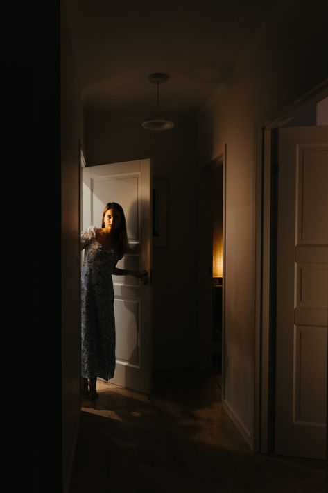 A woman is standing in a dark hallway photo – Free At home Image on Unsplash Night Photography At Home, Doorway Photoshoot, Photoshoot Inspiration At Home, Woman Opening Door, Home Photoshoot Woman, Hallway Photoshoot, Hallway Photography, Door Photoshoot, Hallway Dark