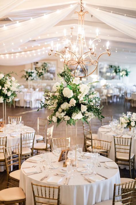 Looking for the perfect centerpieces for your New England wedding?   Check out our website for more beautiful weddings like Allie & Andrews at The Inn at Longshore.  The mix of high and low white centerpieces with delicate greenery accents was just the perfect touch for this beautiful venue.  ⁠ Westport Weddings⁠ New England Wedding Inspo⁠ Wedding Decor⁠ ⁠ High And Low Floral Centerpieces, High Floral Centerpieces Wedding, Timeless Wedding Centerpieces, White And Greenery Wedding Centerpieces, Wedding Tall Centerpieces, Vows Aesthetic, Warehouse Wedding Decorations, High And Low Centerpieces, Head Table Flowers