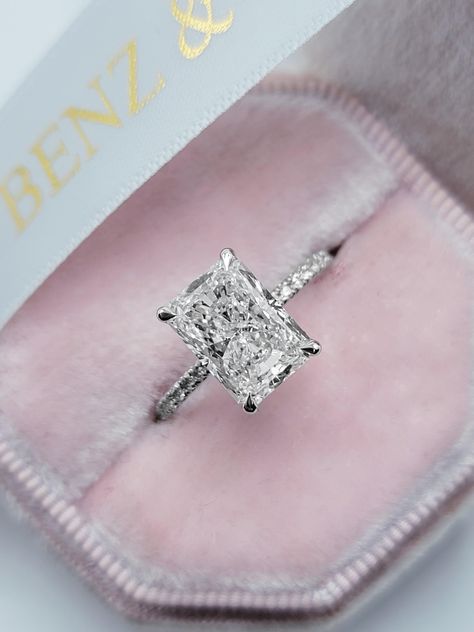 This astonishing 3.54 carats ring has a 3.02 carat lab grown elongated radiant cut center diamond and is IGI certified at "F" in color and "VS1" in clarity, (Excellent Cut, Polish and Symmetry) and is set in a classy side stones hidden halo setting in 14K white gold. The ring can also be made in yellow/rose gold or pla Elongated Radiant, Radiant Cut Engagement Rings, Radiant Engagement Rings, Future Engagement Rings, Engagement Inspo, Emerald Engagement Ring Cut, Halo Setting, Dream Engagement, Dream Engagement Rings