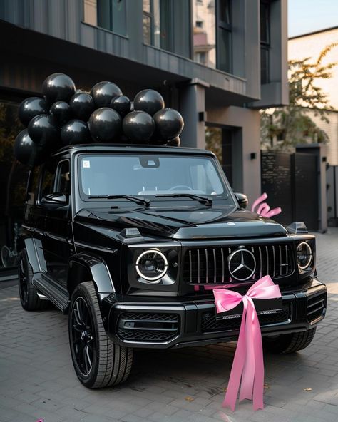 Embrace the elegance of celebration with this breathtaking scene featuring a luxurious black Mercedes-Benz G-Class. Adorned with a charming pink bow and surrounded by sleek black balloons, it's a vision of sophistication. ✨Don't forget to save and follow for more captivating visuals!👉 #LuxuryLifestyle #CelebrationVibes #MercedesBenzGClass #BlackAndPinkElegance #CarGoals #Aesthetic #AIImage G Wagon Vision Board, Mercedes Convertible Aesthetic, Benz C Class Mercedes, G Wagon With Bow, Black G Wagon Pink Interior, G Wagon Gift, Pink G Wagon Mercedes Benz, Mercedes G Class Aesthetic, Black Mercedes Benz Aesthetic