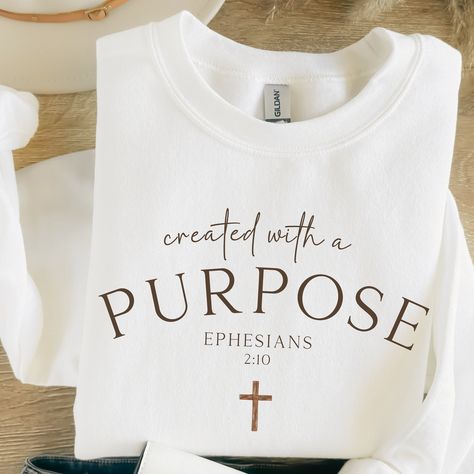 "Created with a Purpose Ephesians 2:10 Crewneck Sweatshirt Inspirational Christian Apparel Comfortable Stylish Faith-Inspired Clothing Gifts Embrace your faith with our \"Created with a Purpose Ephesians 2:10\" crewneck sweatshirt, a stylish and comfortable addition to your Christian apparel collection. This sweatshirt serves as a constant reminder of Ephesians 2:10, which reminds us that we are God's handiwork, created with a purpose. 🌟 Product Features: High-quality crewneck sweatshirt made f Faith Based Apparel, Ephesians 2:10, Christian Products, Created With A Purpose, Jesus Clothes, Printed Gifts, Christian Shirts Designs, Ephesians 2, Faith Clothing