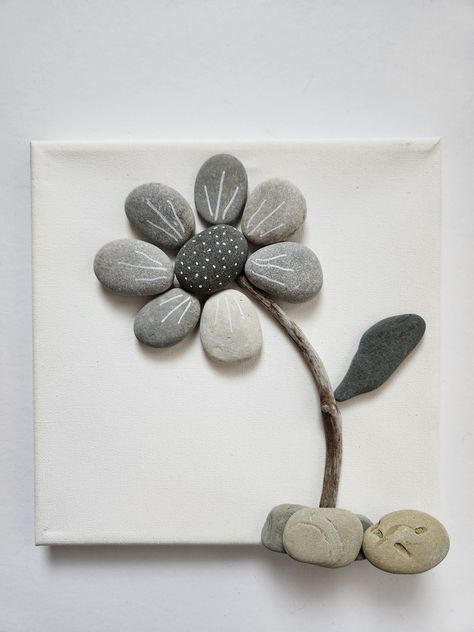 These dainty little black, gray, and white flowers will bring happiness to any room! Lakeshore Rock Art handpicks each rock from the shores of Lake Michigan.  And since no two rocks are the same, we can GUARANTEE that your Rock Art is 100% UNIQUE!  Because of this uniqueness, your final product will look slightly different than the photo above. We do our best to make it as close as possible to the original. Have an idea you would like to see transformed into Rock Art?  Send us a message and we w River Rock Diy Projects, Rock And Twig Art, River Rock Art Pebble Mosaic, Framed Rock Art Ideas, Beach Pebble Art Ocean, Flower Pebble Art Ideas, Stone Crafts Diy Rock Art, Rock Craft Ideas, Glass Rocks Crafts