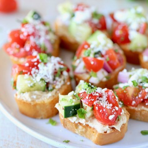 Greek Bruschetta Recipe with Tomatoes & Feta - WhitneyBond.com Greek Bruschetta, Bruchetta Appetizers, Cheese Bruschetta, Easy Bruschetta Recipe, Mediterranean Appetizers, Spring Appetizers, Easy Bruschetta, Easter Food Appetizers, Tomato Bruschetta