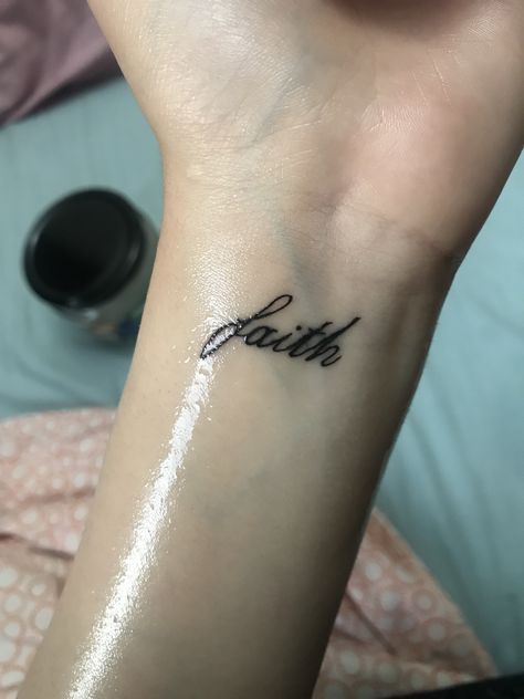 Tattoo Faith Symbol, Faith In Cursive Tattoo, Faith Tattoo Hand, Walk By Faith Tattoo Arm, Faith Wrist Tattoos For Women, Faith Tattoo Wrist, Wrist Word Tattoos, Tattoos For Guys Wrist, Wrist Small Tattoo