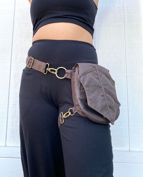 This is the elven, fairy satchel dream. A completely adjustable belt, this has a small strap which can attach to the leg the other around the waist. Your can also extend the waist strap and create a cross body small purse. ALL have silver hardware except for the brown, which is brass.If you are petite you may use the leg strap for your waist and then wrap the leg strap twice around the leg.This is the perfect belt and our newest and best creation :)Measurements: (bag and belt) S/M- 30"-44"(which means that it is on the larger size and if worn on hip must have hip 29" minimum) M/L- 32"-48"(which means that it is on the larger size and if worn on hip must have hip 31" minimum) L/XL- 38"-58" (which means that it is on the larger size and if worn on hip must have hip 38" minimum)The leg strap Fashion Utility Belt, Thigh Purse, Belt Satchel, Hip Satchel, Leg Pouch, Elven Fairy, Halloween Costum, Hip Purse, Thigh Bag