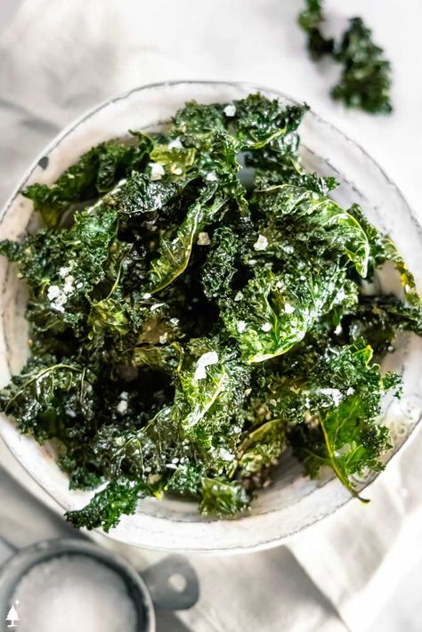 This kale chips recipe adds a crispy element to many a dish or a healthy alternative to the classic potato chip. Salt + delish! #kalechips #lowcarbkalechips Kale Chips Recipe Oven, Kale Chips Oven, Easy Kale Recipes, Kale Chips Recipe Baked, Oven Roasted Zucchini, Kale Chips Recipe, Kale Chips Baked, Garlic Kale, Baked Kale