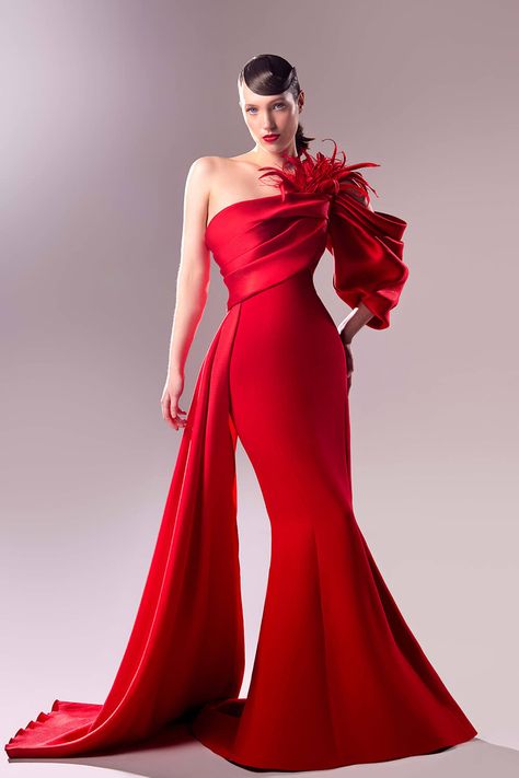 This stunning  evening gown is embroidered in glossy crimson and is a statement of elegance and charm. A delectable cascade of fabric smoothly ascends from the bust, delicately exposes your shoulder before morphing into a dazzling off-shoulder sleeve decorated with tiny organdie and feather inserts for more flair. The mermaid silhouette flatters your contours with obvious elegance, cinching at the waist before erupting into a sweeping train. Haute Couture, Couture, Dress With Side Train, Couture Ideas, Beautiful Evening Dresses, Looks Country, Mexican Outfit, Calf Length Dress, Red Evening Dress