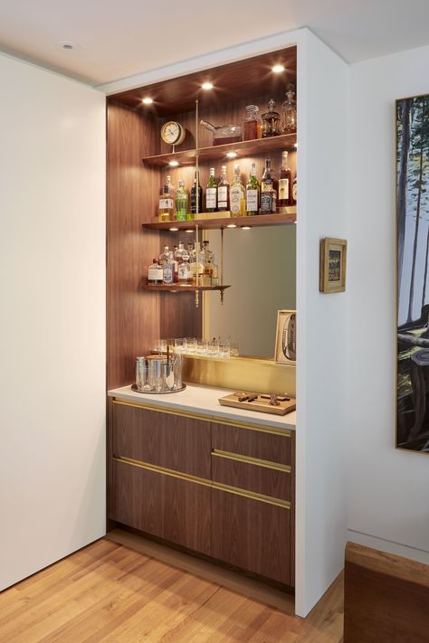 Behind a concealed closet door, this home bar mimics the design of professional setups. Concealed Closet, Built In Bar Cabinet, Small Home Bar Ideas, Modern Home Bar Designs, Home Bar Counter, Small Bars For Home, Home Wet Bar, Home Bar Cabinet, Bar Mini