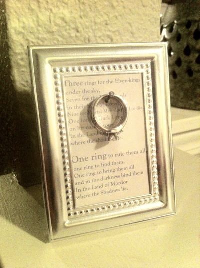 Homemade ring holder using a small frame. The frame idea was from Pinterest--the LOTR quote was my own idea :) You could use any quote you like, really. Lotr Quote, Ring Warming, Small Wedding Rings, Ring Frame, Craft Display, Diy Holder, Three Rings, Fire And Ice, Small Frame