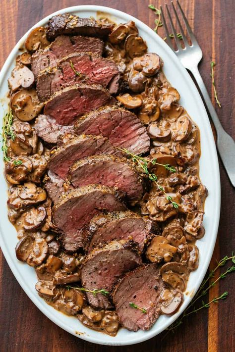 Beef Tenderloin with Mushroom Sauce is a holiday-worthy and impressive main course. Learn how to prep, tie, and cook a beef tenderloin roast in the oven. Mushroom And Meat Recipes, Christmas Main Course Meat, Beef Tenderloin Sauce Recipes, Main Course Christmas Dinner, Mushroom Tenderloin, Truff Recipes, Beef Tenderloin Recipes Oven, Beef Tenderloin Oven, Main Course Ideas