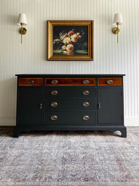 *BUFFET AVAILABLE!* This Hepplewhite buffet turned out divine! This is the first time we have decided to do a black and mahogany two-tone look leaving the upper portion of drawers on a buffet in original condition. This vintage buffet was in spectacular condition for its age but we wanted to take it to the next level. This solid wood sideboard has a whole new modern farmhouse/transitional feel with a fresh matte black exterior as well as the original oval Hepplewhite hardware touched up in brassy-gold for extra shine. The drawers and cabinet portions on either side of this buffet holds plenty of storage and ample space. The top theee drawers don a lovely organic modern style drawer liner. Use this buffet in a dining room, living room, as an entryway console, a media entertainment center, o Dining Room Dresser Styling, Refurbished Buffet Ideas, Buffet Refurbished, Style Buffet Cabinet, Antique Buffet Makeover, Side Board Buffet, Black Buffet Table, Modern Farmhouse Transitional, Two Tone Furniture