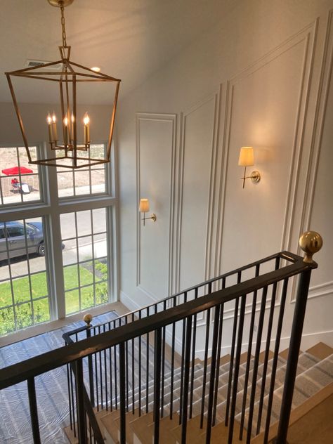 Wall Molding Stairs, Stair Wall Moulding, Double Height Wall Moulding, Picture Frame Moulding Staircase, Stairwell Wainscoting, Two Story Foyer Moulding, Curved Staircase Wainscoting, Mcm Atrium, Tall Staircase Wall Ideas