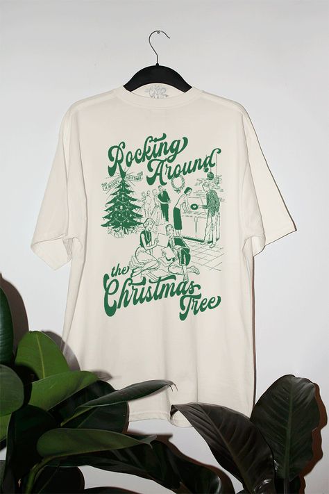 Start Rocking Around the Christmas Tree in our super cozy oversized tshirt, just in time for the Holiday season!- Features a Christmas party with the phrase "Rocking Around the Christmas Tree" around it all in a deep green ink- Screen print transfer that is individually heat pressed onto each tshirt- Printed on a vintage wash, super soft tshirt that gets softer with each wash- 100% Cotton- Oversized fit- Sizing translation: XS/S - L , S/M - XL , L/XL - 2XL , 2XL/3XL - 3XL**due to screens & filte Cool Christmas Tshirts, Holiday Shirt Designs, Retro Christmas Tshirt, Christmas Design Tshirt, Vintage Christmas Shirts, Christmas Shirt Design Ideas, Christmas Tshirt Ideas, Christmas Tshirt Designs, Outfit Ideas Shirt