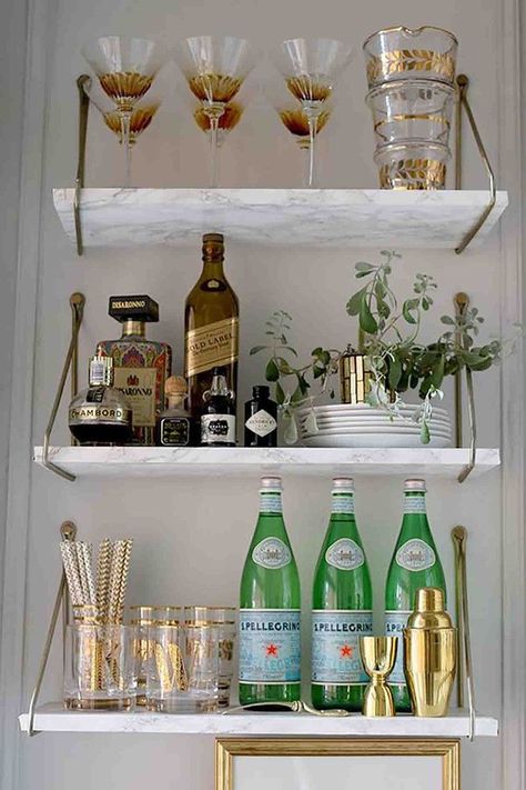 Add a touch of luxury to your small indoor bar with these marble shelves. They look elegant, impressive and are super easy to clean!SwoonWorthy has created this gorgeous DIY bar shelf in the corner of her dining room. It fits perfectly in the space and is easy to reach when hosting dinner parties. Bar Shelf Ideas, Art Deco Bar Cart, Modern Bar Cart, Diy Bar Cart, Gold Bar Cart, Art Deco Bar, Bar Cart Styling, Bar Shelf, House Decor Modern