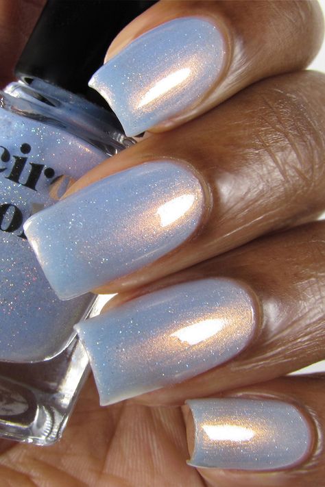 Hygge (pronounced HOO-GAH which means "cozy" in Danish) is a sheer light blue nail polish with strong copper shimmer and delicate holographic sparkle. Our shimmer polishes are packed with glimmering pigments which give them a unique multidimensional. Frosted Nail Polish Colors, Shimmery Light Blue Nails, Light Blue January Nails, Sparkly Light Blue Nails, Light Blue Glitter Nails, Ice Nails, Holographic Nail Designs, Light Blue Nail, Light Blue Nail Polish