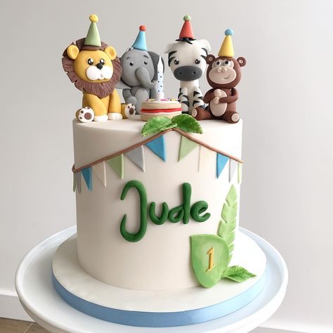 Celebrating Jude’s 1st trip around the sun with this sweet safari animal cake! 🎂 💚 A delicious lemon flavoured cake decorated with handmade fondant safari animals all wearing their party hats ready to celebrate! 🥳 🦁 🐘 🦓 🐵 After having made Jude’s Christening cake last year, it’s a privilege to have now made his 1st birthday cake! I love when my cakes play a part in your milestone celebrations! Here’s to many more joyful years ahead 🎈 #safaricake #partyanimalscake #junglepartycake #1stbir... Jungle 2nd Birthday Cake, Birthday Cakes For Baby Boys 1st, First Birthday Cake Animals, 1 Year Bday Cake, Animals Cakes Birthday, 1 Year Birthday Cake Ideas, Baby Boy First Birthday Cake Ideas, Safari Cake Birthday, Cake Safari Birthday