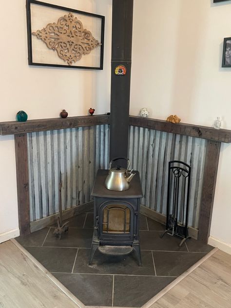 Metal Wood Stove Backing, Wood Stove Corner Wall, Tiles Around Wood Stove, Wood Stove Stand, Pedestal Wood Burning Stove, Modern Rustic Wood Stove, Tin Wood Stove Surround, Wood Burn Stove Living Room, Cast Iron Wood Stove Ideas