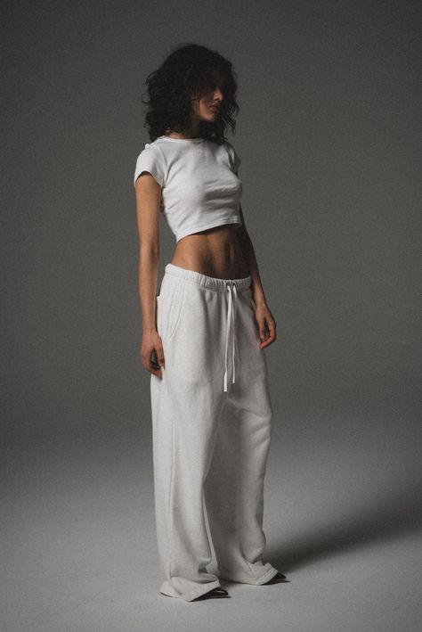 An elevated loungewear essential. The Core Straight Leg Sweatpant is made of a 12 oz cotton with a wide-leg, baggy silhouette. Includes a drawstring waistband, side pockets, and back pocket for added functionally. 100% ORGANIC COTTON 12 OZ BRUSHED TERRY STANDARD FIT MID RISE GARMENT WASHED INSPIRED BY VINTAGE GARMENTS Sweatpants And Sandals Outfit, White Sweat Set, Comfortable Street Wear, 100% Organic Cotton, 100% Cotton Clothes, White Wide Leg Sweatpants Outfit, Vintage Sweat Pants, Monochromatic Sweats Outfit, Feminine Workout Clothes