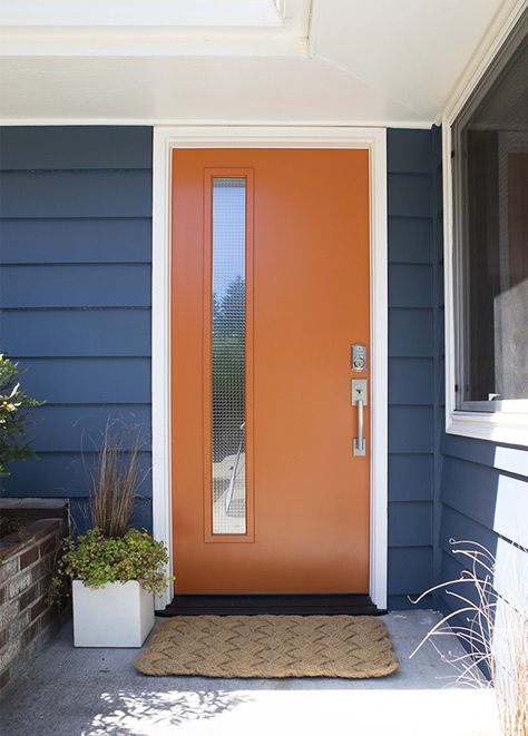 Mid Mod Front Doors, Mid Century Front Door Ideas, Navy Blue House Exterior Orange Door, Color Pop Front Door, Mcm Exterior Door, Mid Century Door Colors, Mid Century Orange Door, Mid Century Modern Home Exterior Paint Colors, Rustic Orange Front Door