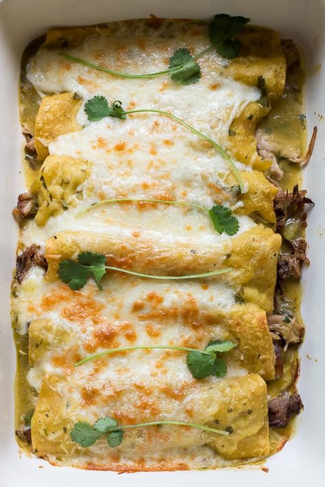 Pork Verde Enchiladas made easy with slow cooker pulled pork. Finish the enchiladas off in the oven for a perfect dinner. #enchiladas #crockpot #pork - The Magical Slow Cooker Pulled Pork Green Chile Enchiladas, Smoked Pork Enchiladas, Pulled Pork Enchiladas Green, Pork Chili Verde, Casserole Enchilada, Pork Verde, Verde Enchiladas, Grill Dinner, Paleo Casserole