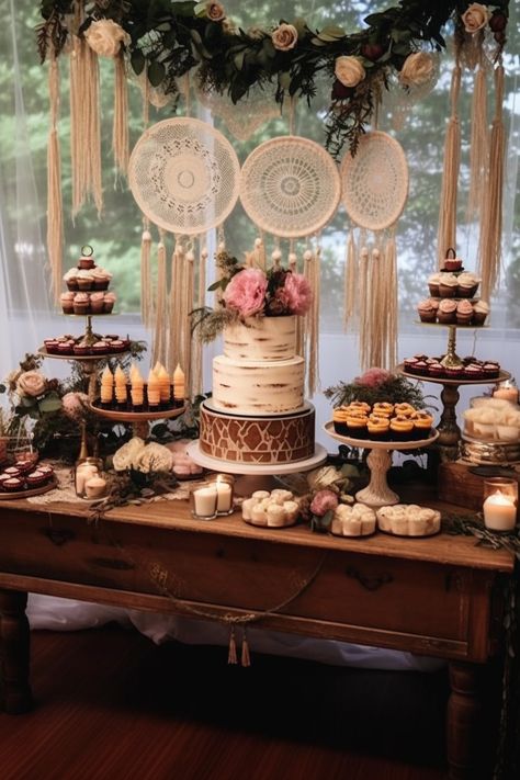 Immerse yourself in the enchanting world of a bohemian themed wedding dessert table, featuring light maroon and bronze accents. The multilayered dimensions and light pink hues create a dreamy cabincore setting. Indulge in this whimsical feast for the eyes! Bohemian Dessert Table, Boho Dessert Table, Boho Food, Wedding Cake Table Decorations, Dessert Display Wedding, Wedding Cake Dessert Table, Boho Backdrop, Boho Wedding Cake, Boho Cake