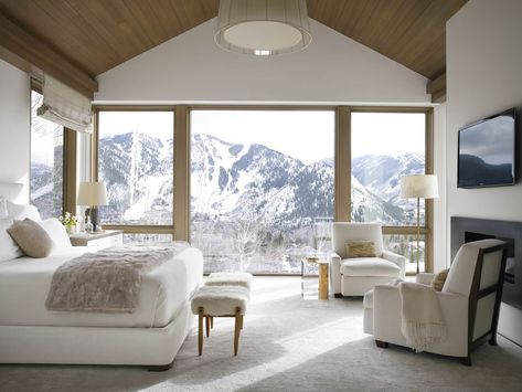 The blinding white walls and Mansour carpet pay homage to the snow-covered mountains surrounding this Aspen getaway. A bedside table from designer Victoria Hagan’s home collection matches the custom bed by Classic Design and E. Braun & Co. linens. The Roman Thomas chairs are upholstered in a Donghia fabric. The vintage stools are from Pascal Boyer Gallery, and the Roman shade is in a Romo fabric. Large Window, Colorado Homes, Minimalist Room, White Furniture, Master Bedrooms Decor, Dream Spaces, White Bedroom, Beautiful Bedrooms, Bedroom Colors