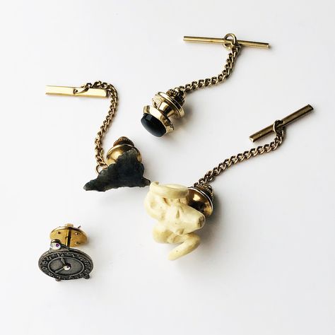 "We came across a small collection of unique vintage tie tacks ready to up your individual style. Review the photos and select the one(s) you want from the options available. Here's what's available: 1) Faux ivory Rams Head tie tack with gold tone chain - 7/8\"(24mm) wide 2) Indian Arrowhead made out of carved stone with gold tone chain - 75\" (20mm) tall 3) Alarm Clock with rhinestone accents with gold-tone chain - .75\" (20mm) tall 4) Faux black onyx stone on gold-tone base with gold-tone chai Gold Tie Chain Design, Goth Tie Clip, Luxury Vintage Adjustable Bolo Ties, Gold Tie Clip, Head Ties, Unique Ties, Fashion Hub, Black Onyx Stone, Tie Tack