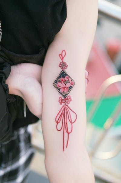 Lotus flower good luck charm tattoo | www.otziapp.com Korea Tattoo, Charm Tattoo, Petit Tattoo, Korean Tattoos, Birth Flower Tattoos, Asian Tattoos, Tatuaje A Color, Japanese Sleeve Tattoos, Red Tattoos