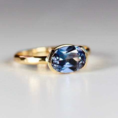 This beautiful oval lab grown color change sapphire ring was made of 8mmx6mm oval sapphire stone in 14k gold half bezel bezel setting and 14k yellow gold 2mm hammered band. It's perfect as a solitaire engagement ring or statement ring. DETAILS Ring Band: 14K YELLOW GOLDRing Band size: 2mm wide x 1mm thick half roundRing Band is hammered or smooth by requested.Gemstone: Lab grown color change sapphireGemstone size and cut: 6x8mm oval cutCarat weight : 1.25 ct. weightGemstone Quality : AAA *** All East West Oval Sapphire Ring, Half Bezel Sapphire Ring, Vintage Sapphire Engagement Rings Gold, Modern Sapphire Engagement Ring, Bezel Set Gemstone Ring, Bezel Set Sapphire Ring, Bezel Sapphire Ring, Bezel Sapphire Engagement Ring, East West Half Bezel