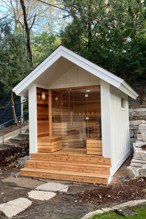 This sauna build features clear western red cedar walls, benching, bench skirts, and backrest.  We built the floor with cedar deckboards.  It has strip lighting on the backrest, a ceiling light and two lights outside of the sauna.  It features a Finnleo Himalaya Rock Tower Heater and a SaunaLogic 2.0 Smart Control. Luxury Outhouse Ideas, Backyard With Sauna, Wellness Shed, Build Sauna Outdoor, Outdoor Infrared Sauna Ideas Backyards, Sauna On A Trailer, Home Spa Outdoor, Outdoor Home Sauna, Sauna In The Garden